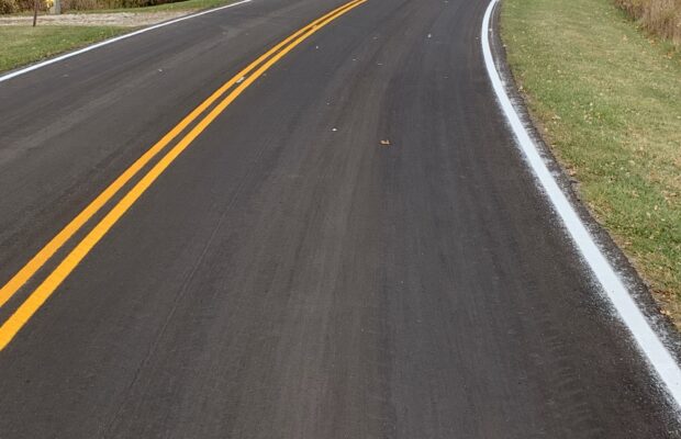 Road with cured miro surfacing treatment applied