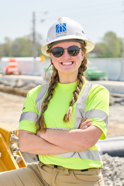 Young female construction worker smiling at a construction site